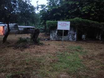 Abandoned rustic building on overgrown lot near Las Lajas surf beach Panama