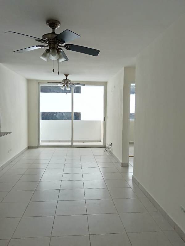 Open-plan living dining with tile floors, ceiling fans, sliding balcony doors in PH Green Park San Miguelito Panama