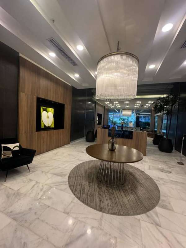 Stylish lobby with marble floors, large chandelier, reception desk, seating area in PH Oceanaire Punta Pacifica