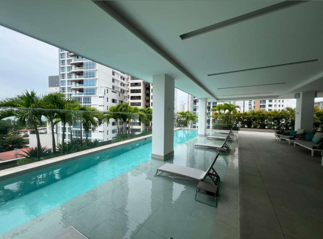 Modern bathroom with textured tiles, glass shower enclosure, double vanity and city skyline view in PH Coco del Mar Panama