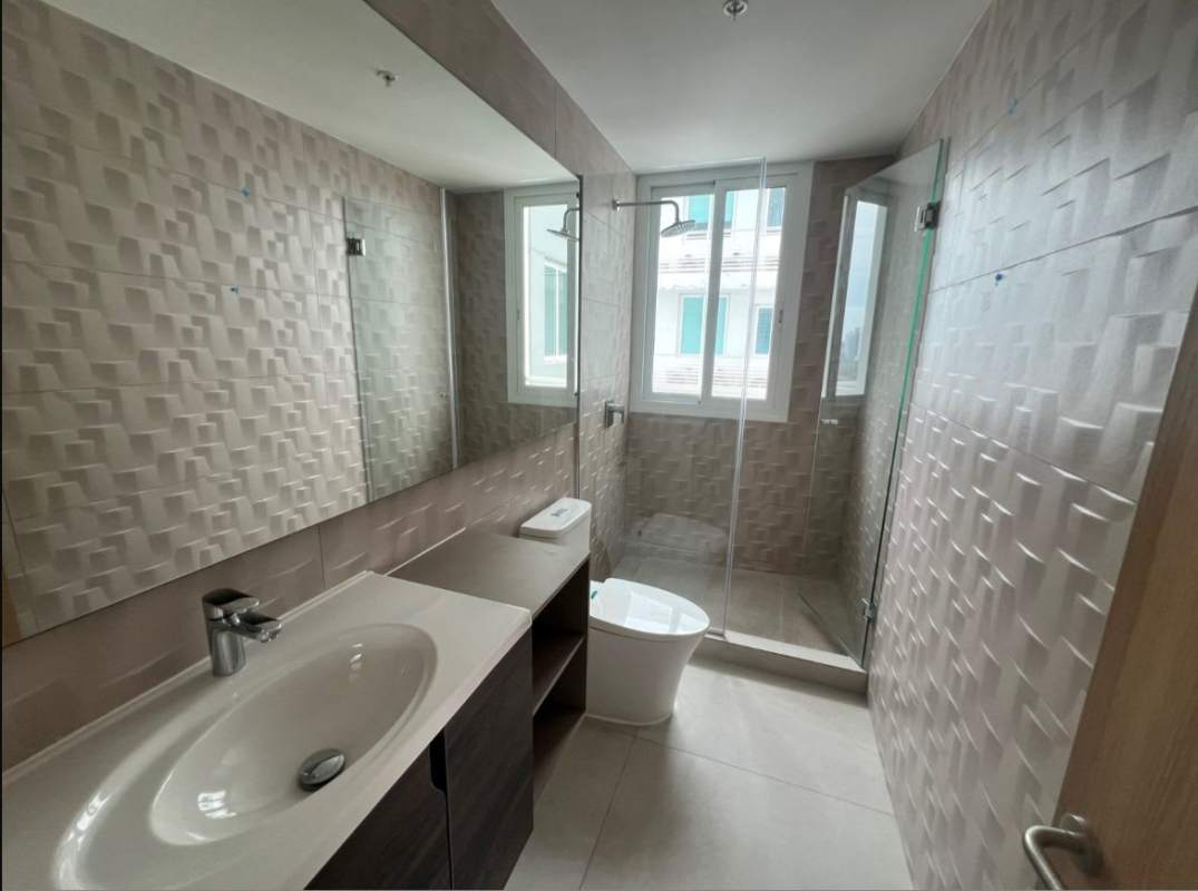 Bathroom with large window and city skyline, textured tiles, double vanity PH Coco del Mar