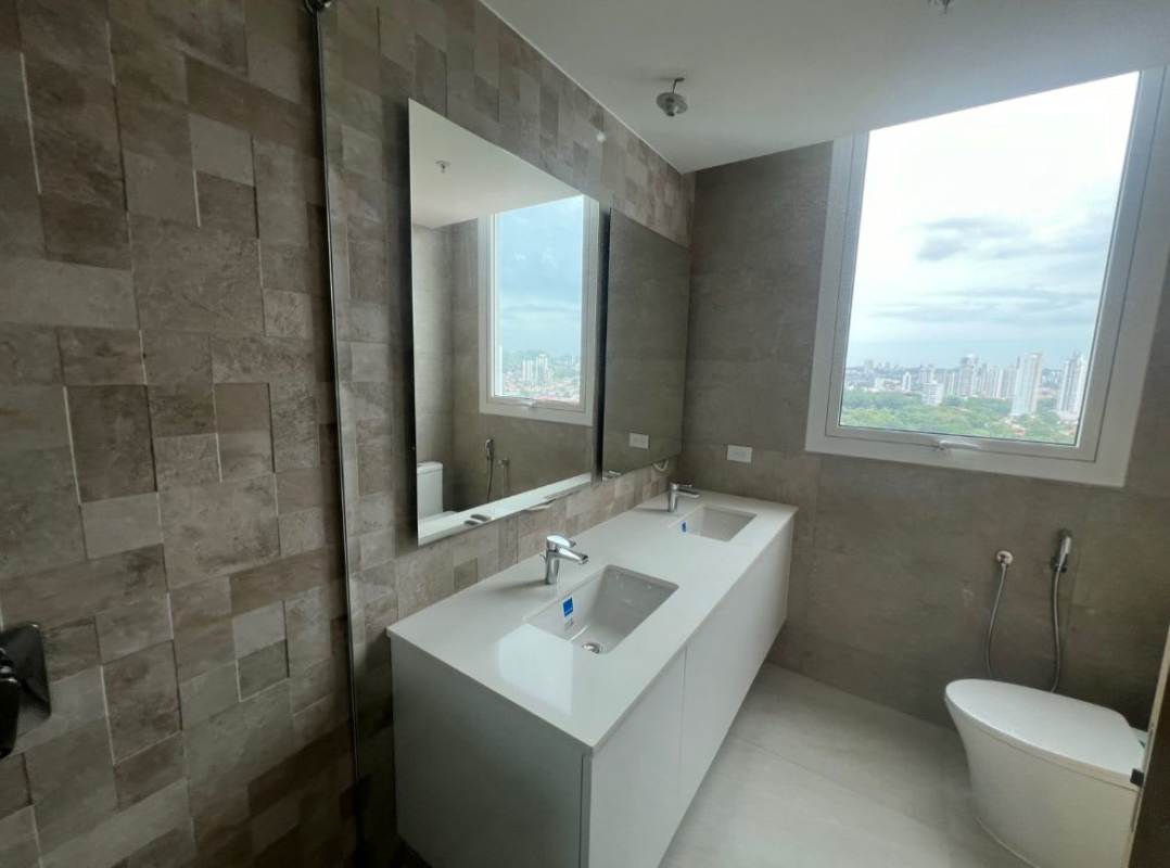 Modern minimalist kitchen with island, built-in oven, cooktop and city views in PH Coco del Mar Panama