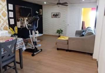 Living room with TV, floral wallpaper and exercise space Villas del Lago Panama