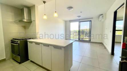 Open kitchen with granite counter, stainless appliances and pendant lighting at PH Madeira Panama Pacifico