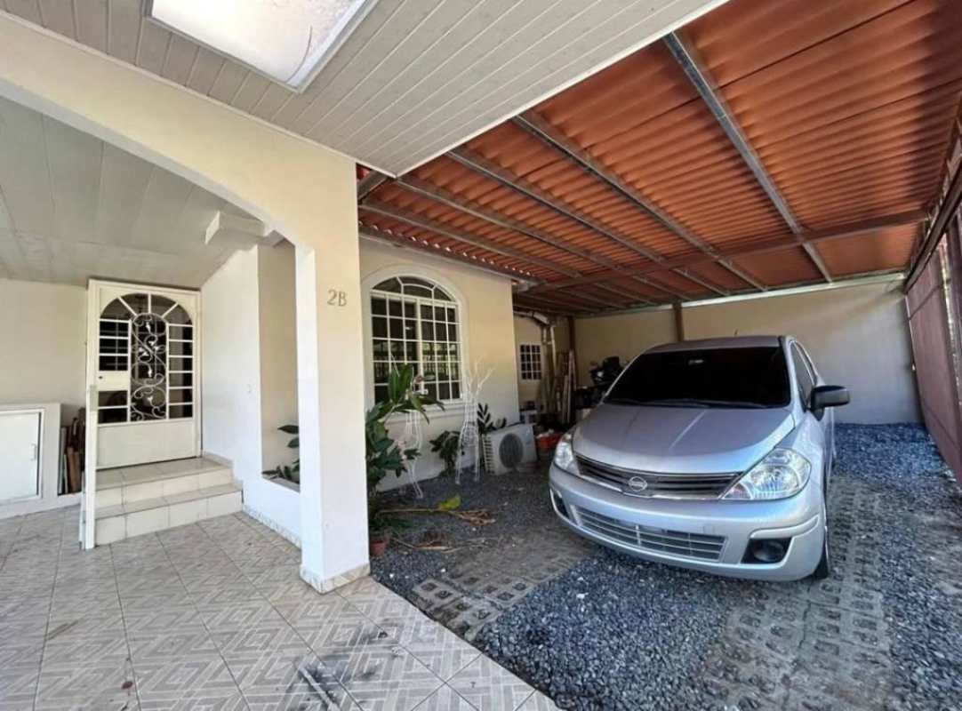 Garage with arched entryway and tiled floors Villa Zaita house Panama City