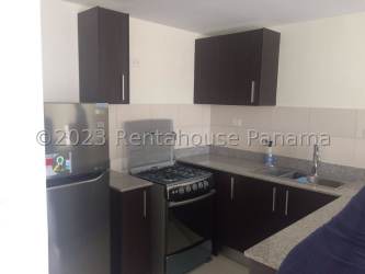 Modern fitted kitchen in Panama Pacifico with dark cabinets and granite counters