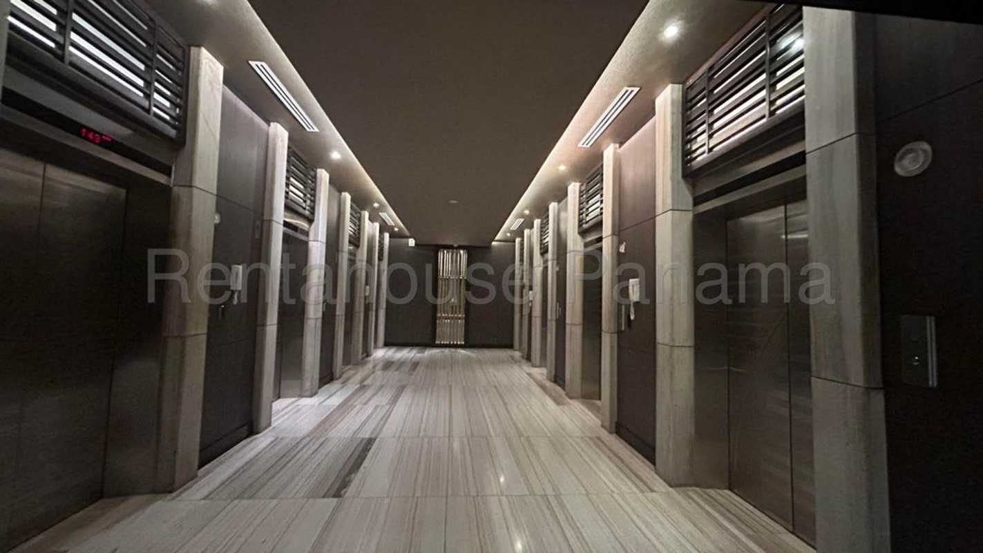 Modern kitchen with granite counters, island, stainless appliances in ocean view apartment