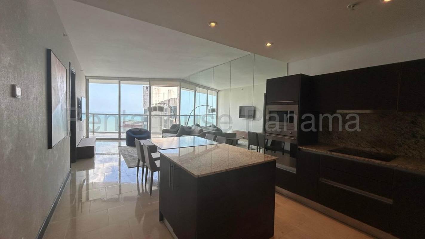 Living room with floor-to-ceiling windows, ocean views, stylish furnishings in Punta Pacifica Panama