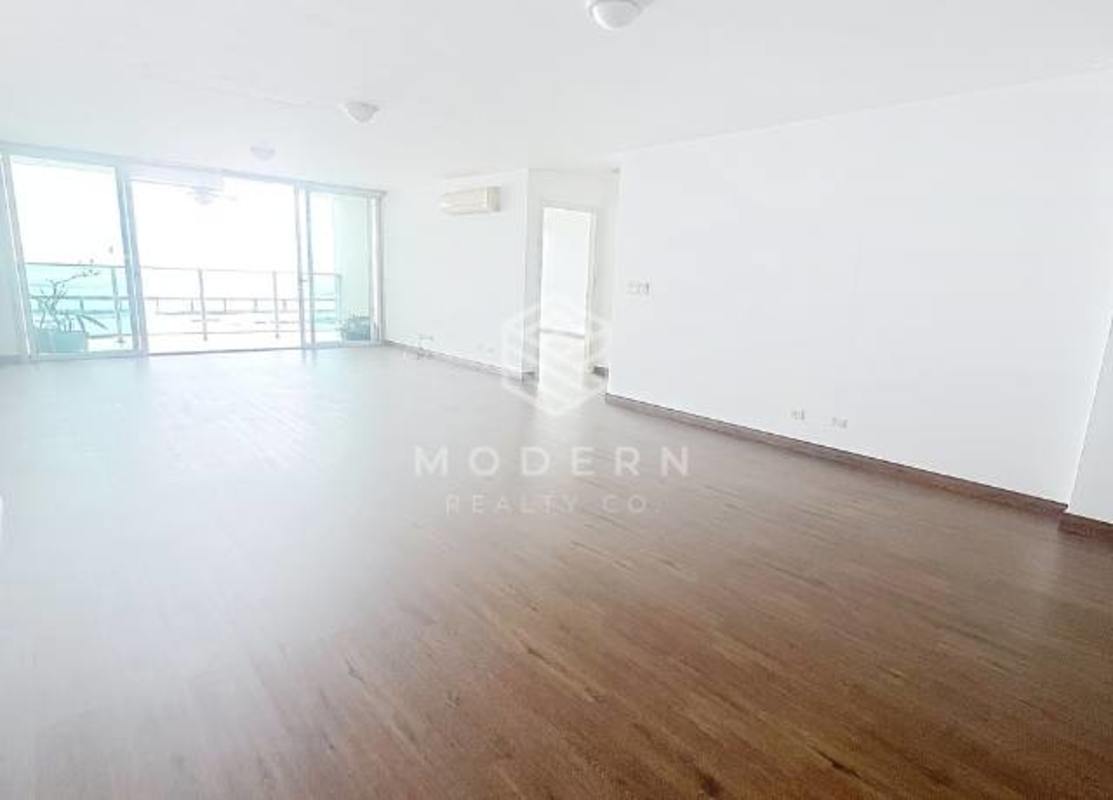 Bright living room with wooden floors opening to oceanview balcony PH Riverside Tower Coco del Mar Panama