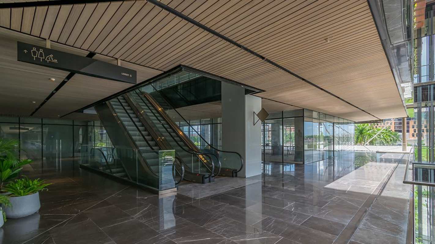 Lobby with marble floor, glass walls, escalators and wood ceiling Panama Design Center Costa del Este