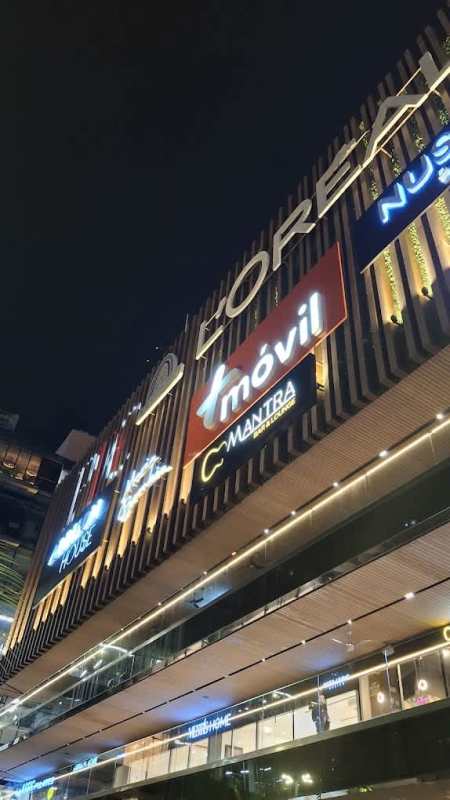 Night view retail storefronts illuminated Panama Design Center Costa del Este Panama