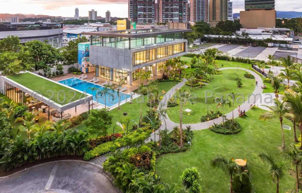 Sky view of modern condo complex with large pool gardens rooftop lounge