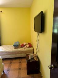 Spacious kitchen with dark wood cabinetry and appliances in farm estate house Río Hato Panama