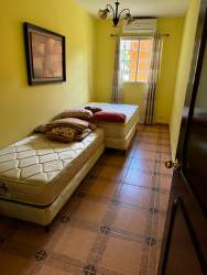 Single-story cottages with orange walls and garden areas in estate for sale on Interamericana Río Hato Panama