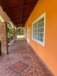 Round outdoor pool with green lawn and palm trees at farm estate near beach resorts Panama