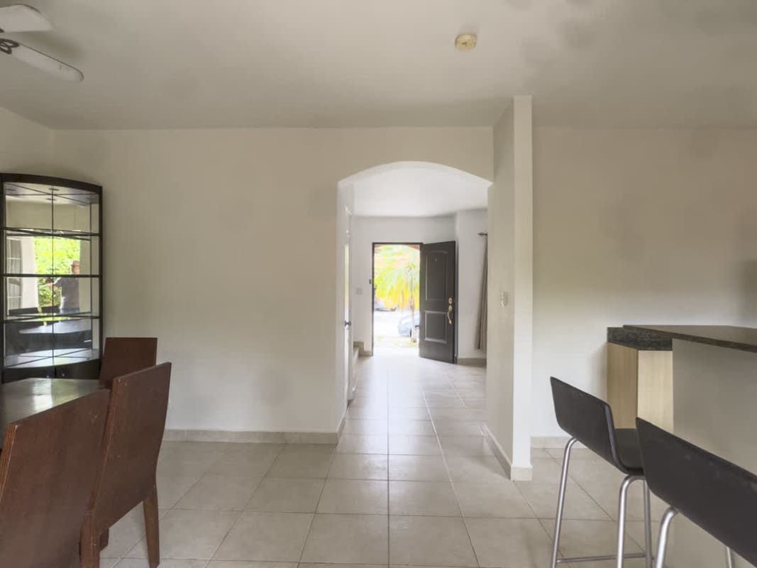 Spacious kitchen with granite countertops open to dining room in Versalles Costa Sur