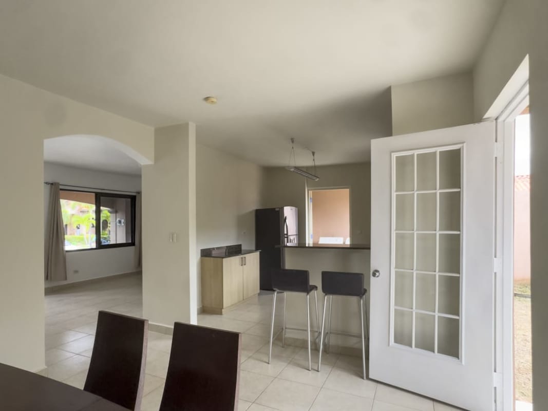 Living area with staircase, tile flooring, split AC unit in Versalles Costa Sur Panama house