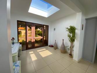 Covered patio terrace with lounge seating dining area garden pool Villas Decameron Rio Hato