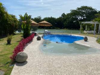 Spacious living room with high ceiling, sliding glass doors to pool at Villas Decameron Rio Hato Panama