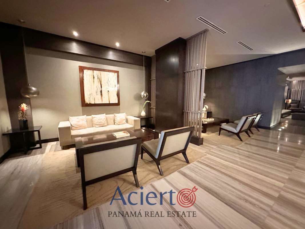 Bright living room with panoramic windows, tile floors, and balcony ocean view in JW Marriott Panama condo Punta Pacífica