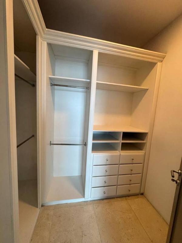 Closet with built-in white drawers and shelving PH Q Tower Punta Pacifica Panama