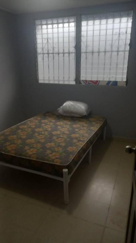 Minimal bedroom with bed frame and window bars, affordable rental in PH Residencial Santa Elena Panama City