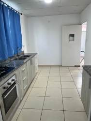 Kitchen with granite countertops, built-in stove, blue curtain Brisas del Golf Arraiján Panama