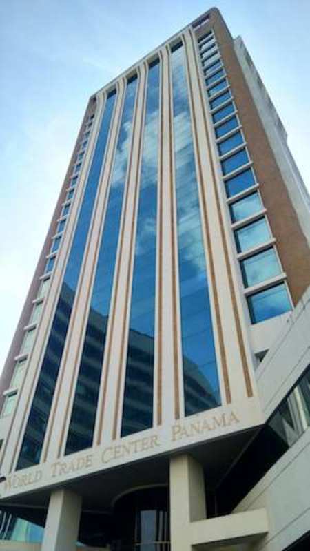High-rise office tower with vertical design and mirrored glass facade in Panama City