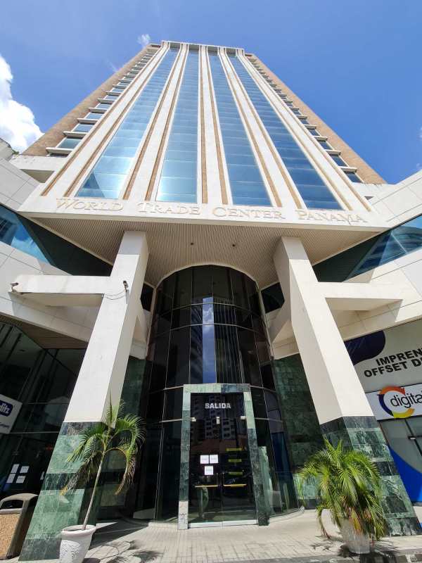 Main entrance with glass facade and marble columns at World Trade Center Panama in Marbella