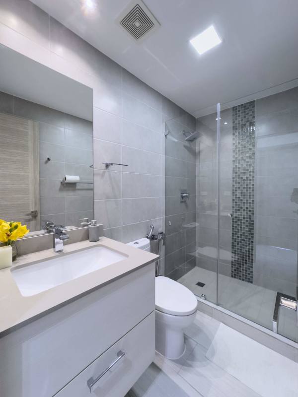 Bathroom featuring glass walk-in shower and large mirror at The Towers in Punta Pacifica