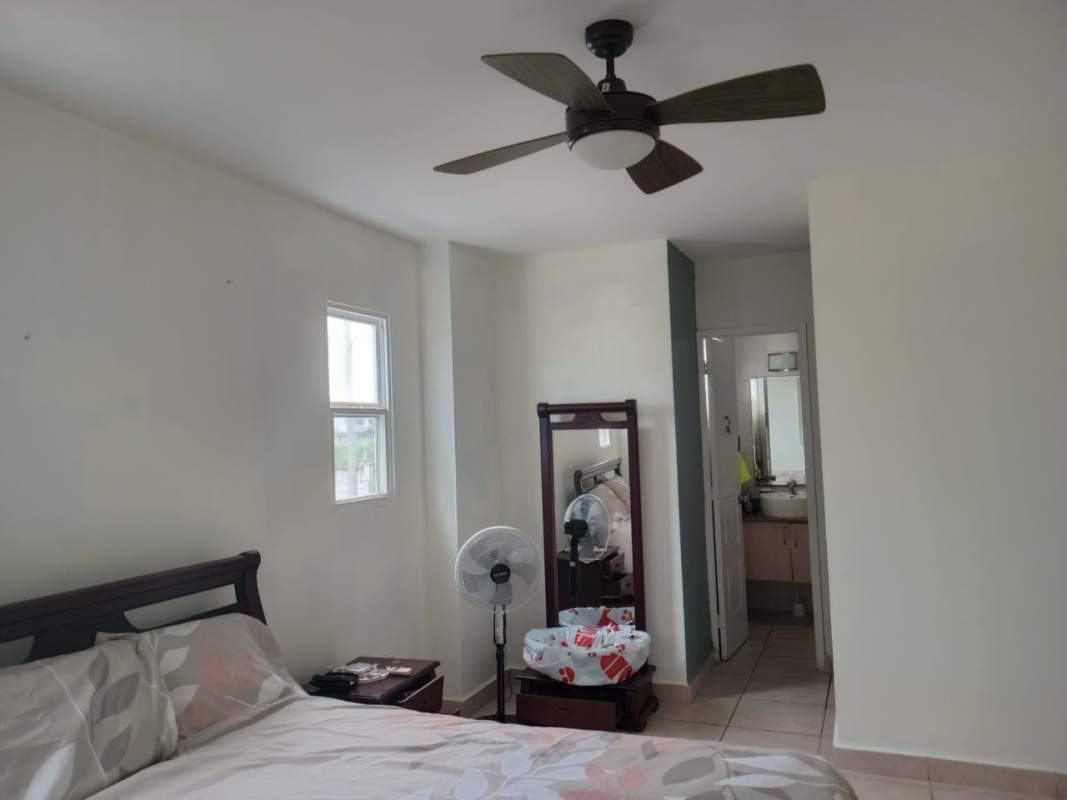 Bedroom with bathroom view, ceiling fan, tile floor PH Alpes Panama