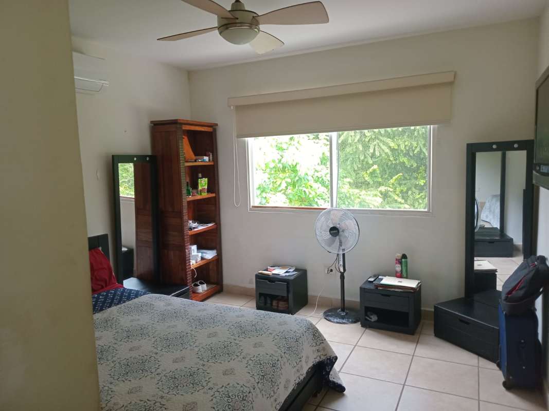 Bedroom with garden view window, tile floor ceiling fan PH Alpes Panama