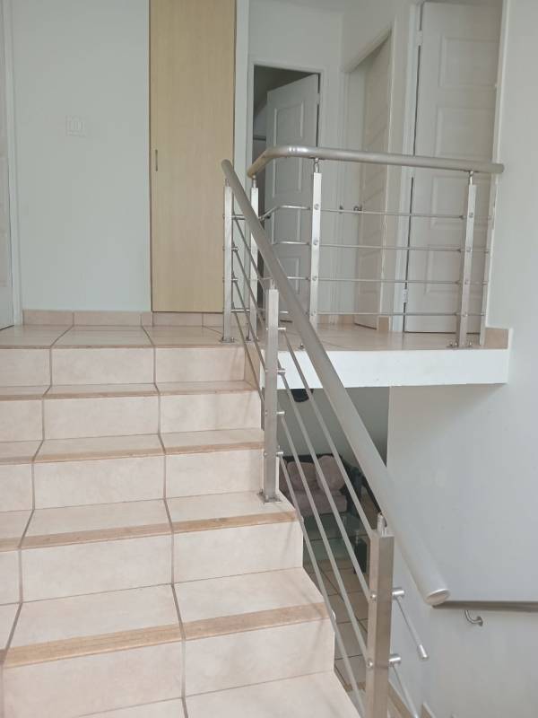 Interior staircase with ceramic tiles and metal railing PH Alpes Panama