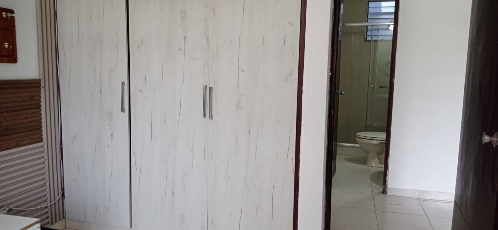 Bedroom featuring built-in wardrobe and connected bathroom in PH McGregor apartment