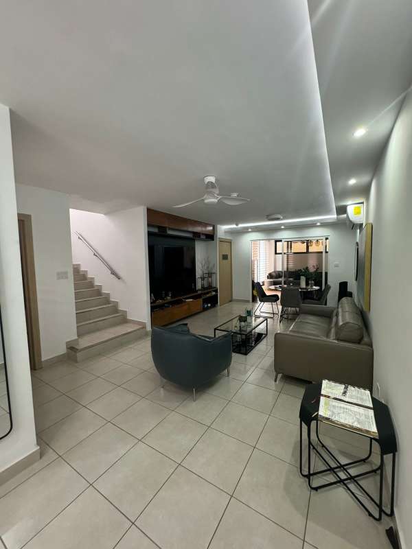 Dining area with living space and staircase inside PH Alpes residence in Brisas del Golf