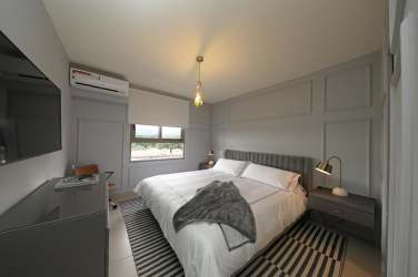 Outdoor pool with lounge chairs in PH Madeira Panama Pacifico residential