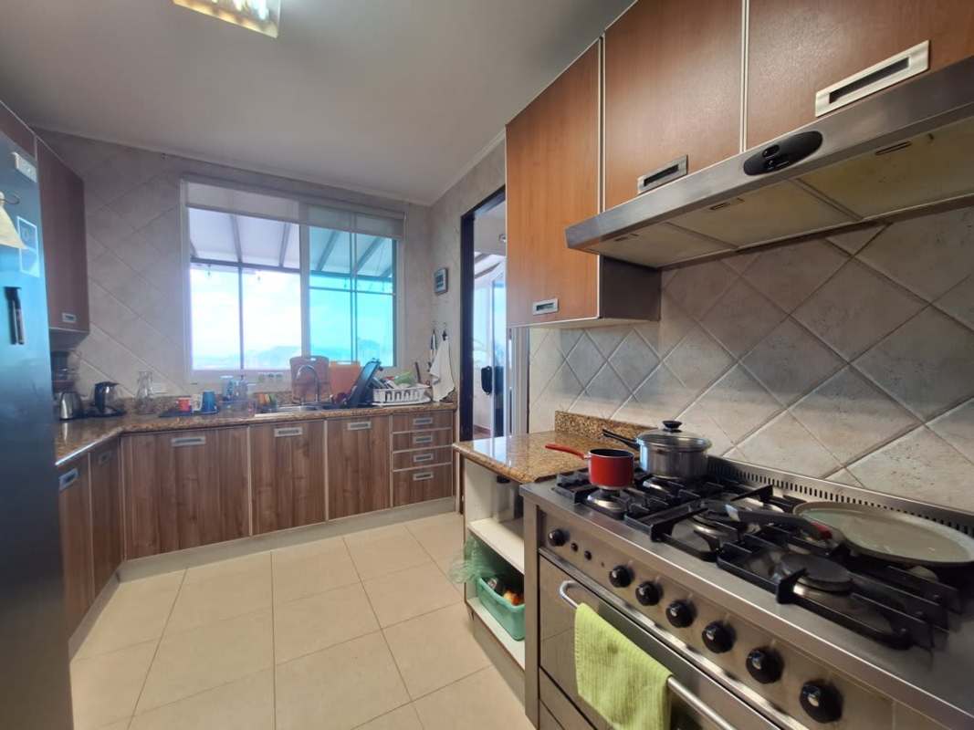 Spacious living room with sliding doors, study space, large windows in PH Costa Pacifica Panama