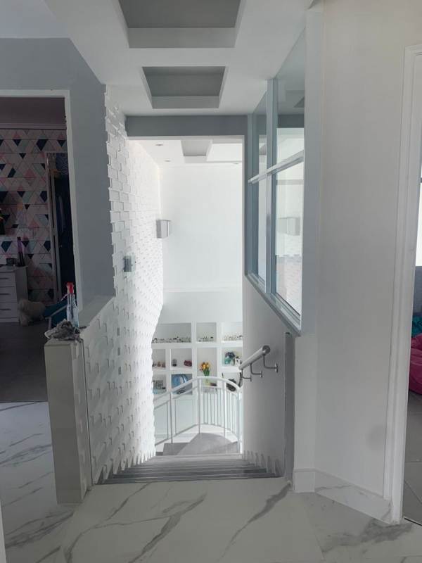 Modern remodeled kitchen with island, quartz counters, stainless appliances in luxury penthouse Panama