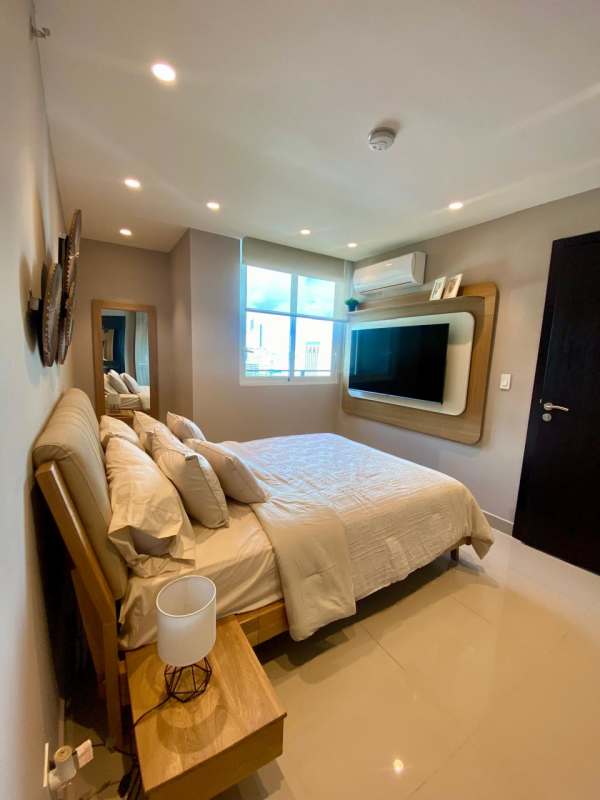 Bedroom with wall-mounted TV, built-in wardrobe, modern lighting in Bella Vista Panama