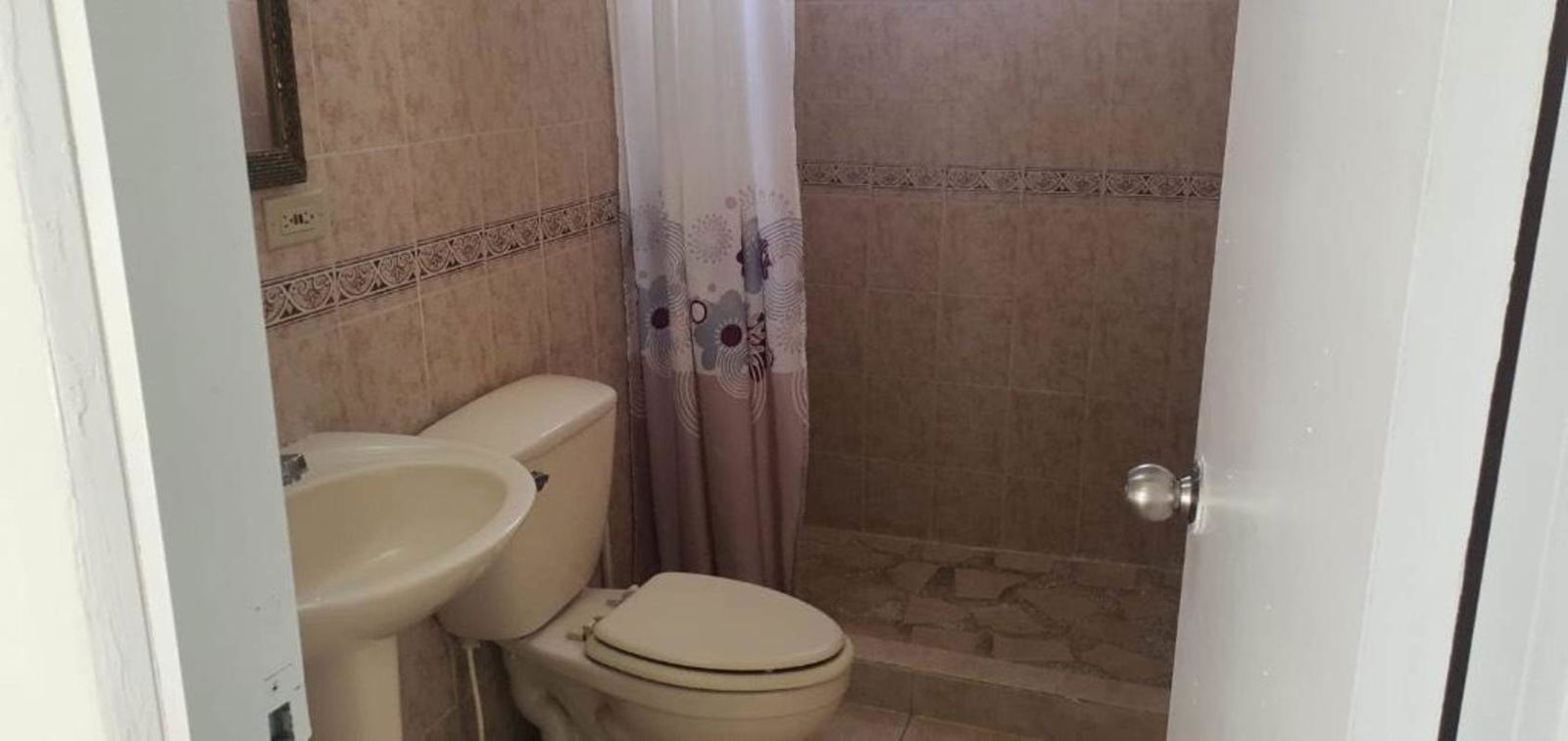 Small bathroom with tile, pedestal sink, and shower at PH Forest View Panama