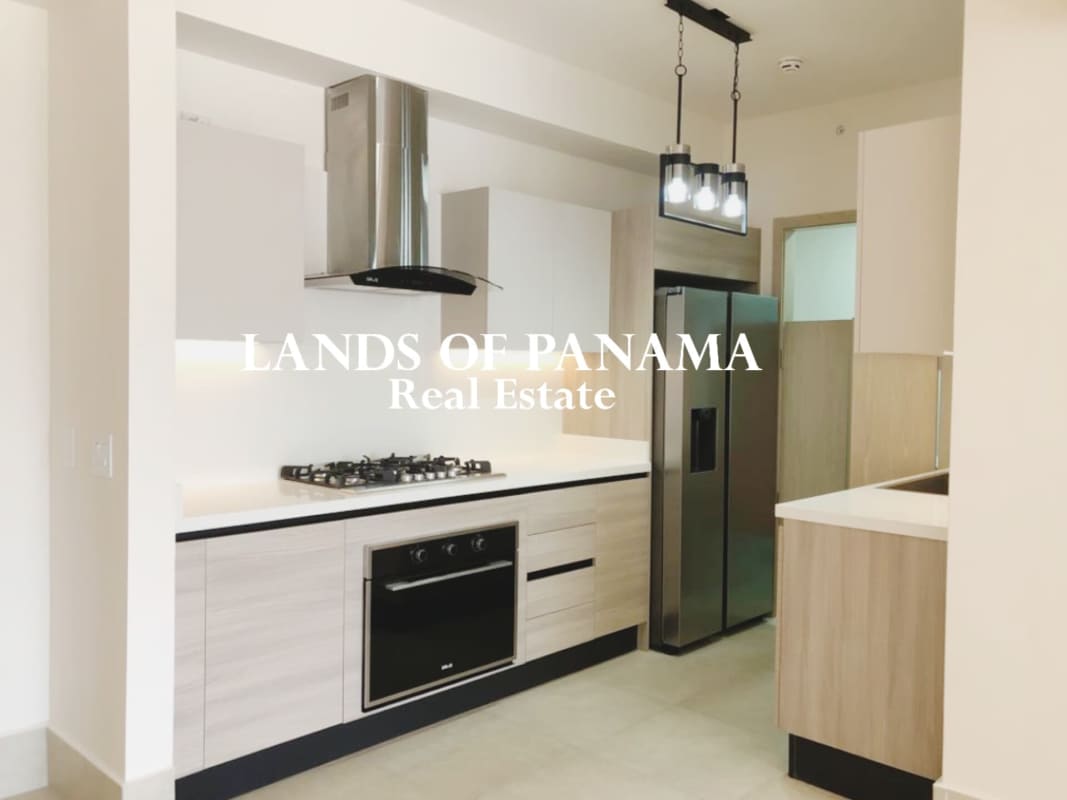 Open concept modern kitchen with stone counters and porcelain floors in apartment PH Ocean House Santa Maria Panama