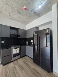 Rooftop infinity pool and lounge chairs atop PH Centriqo Panama Pacifico.