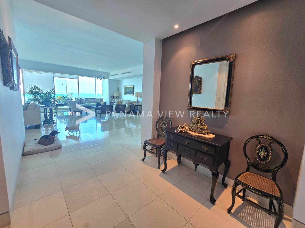 Spacious dining and living area with chandelier at PH Ocean One Costa del Este Panama
