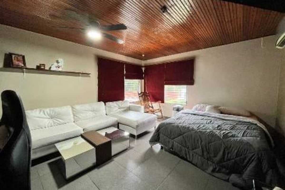Spacious living and dining room with sofa, pool table, modern lighting Villa Zaita Panama