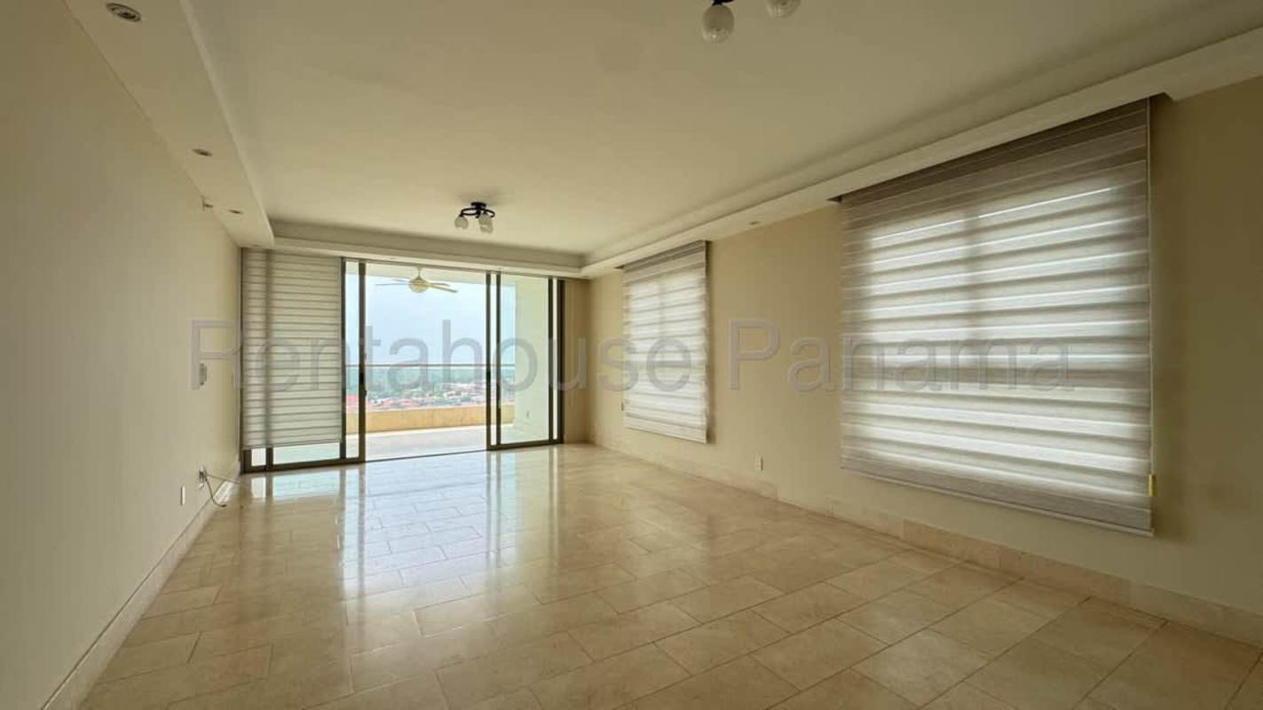 Open plan living room with panoramic windows and marble floors in Santa Maria Golf apartment for rent