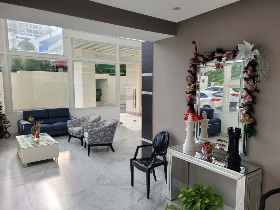 Contemporary lobby with marble floors and blue sofas PH Edison Park Panama City