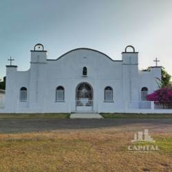 White stucco church building with lawn near the land lot in Rio Hato Coclé Panama