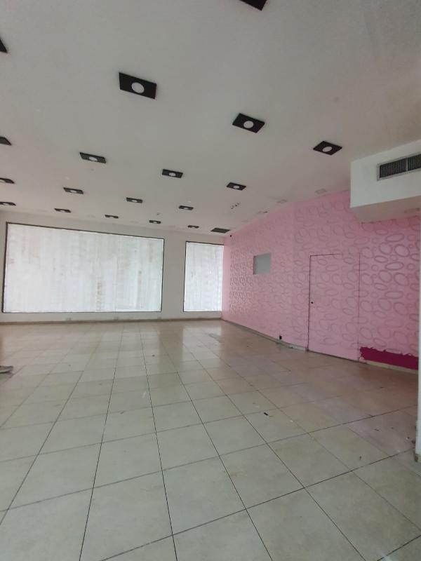 Empty commercial interior with floor-to-ceiling windows and accent wall inside Albrook Mall Panama
