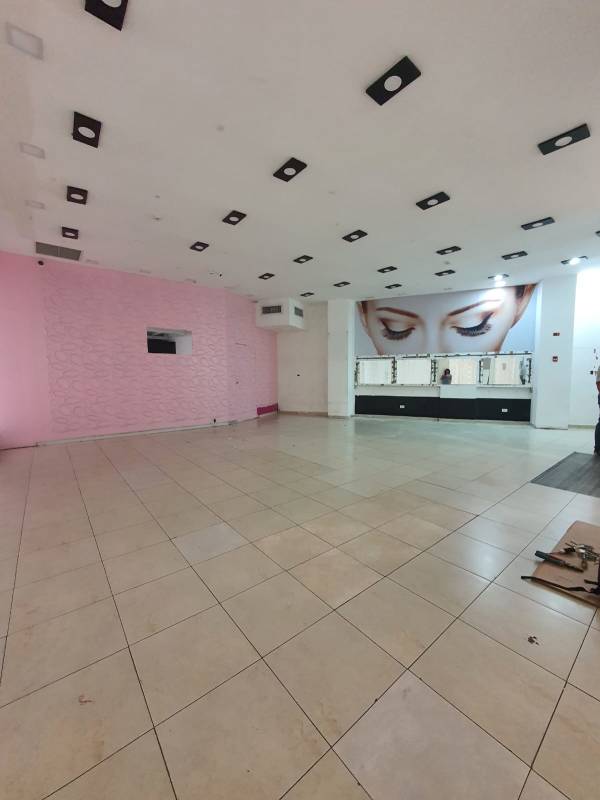 Pink accent wall commercial retail showroom with tile flooring, lighting and graphic design at Albrook Mall Panama