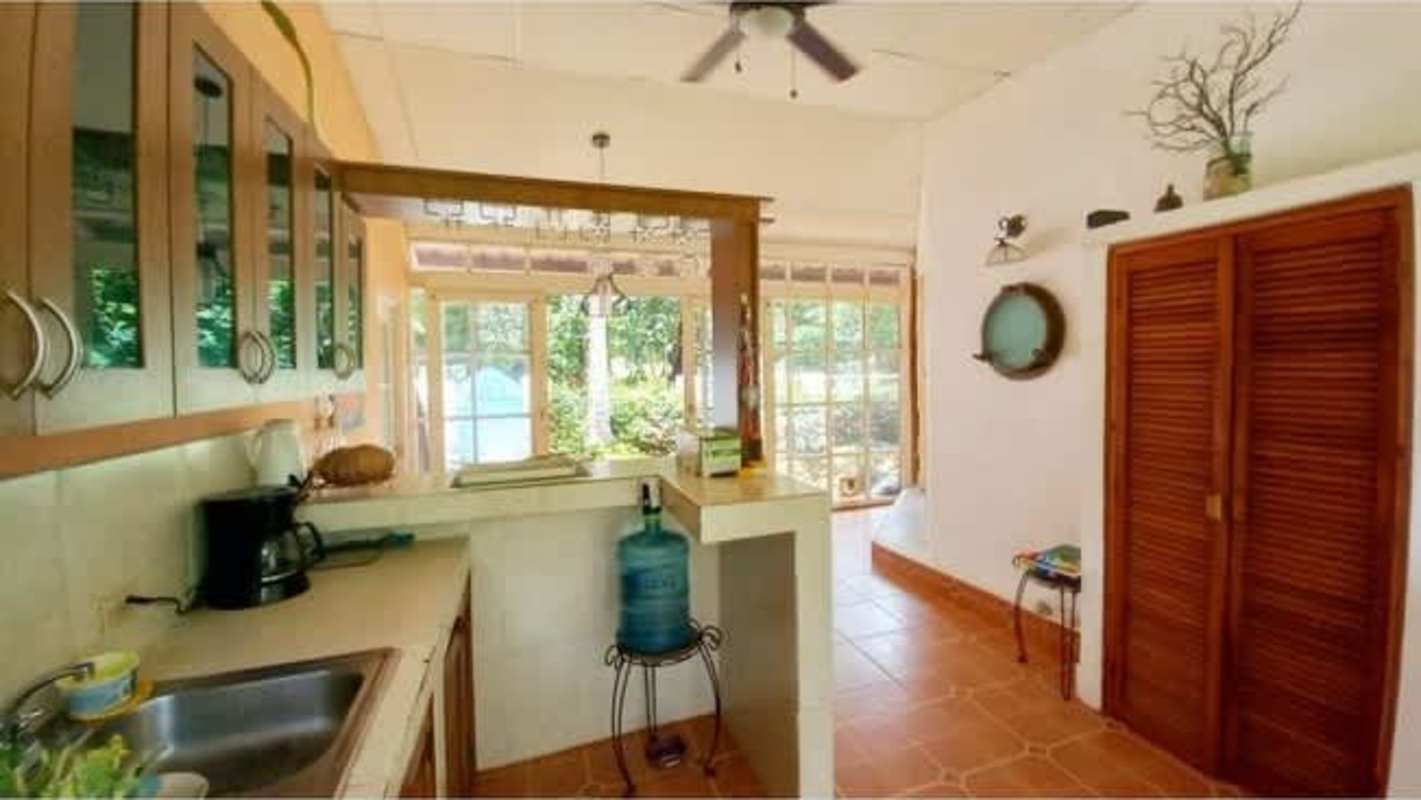 Bright rustic kitchen with garden views and wood details beach house Isla Contadora